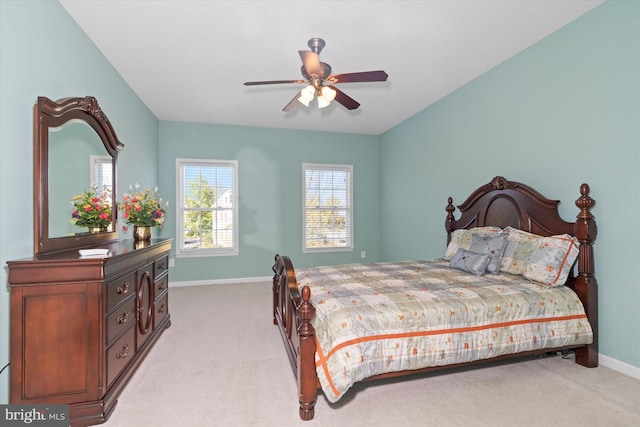 bedroom featuring light carpet and ceiling fan