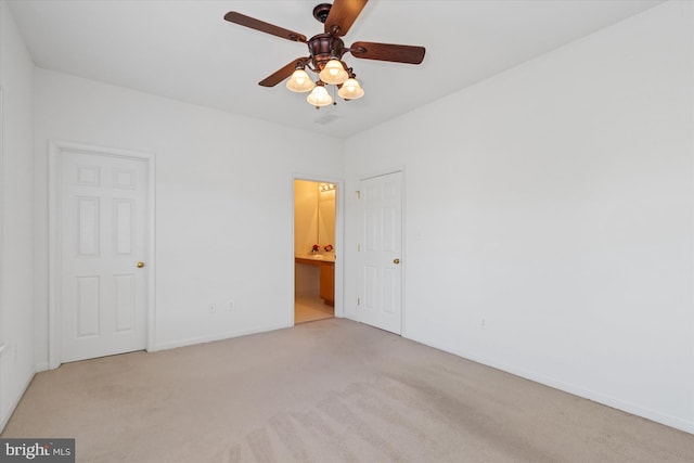 empty room with ceiling fan and light carpet