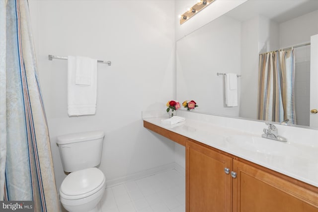 bathroom with tile patterned floors, vanity, and toilet