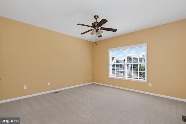 empty room with ceiling fan and light colored carpet