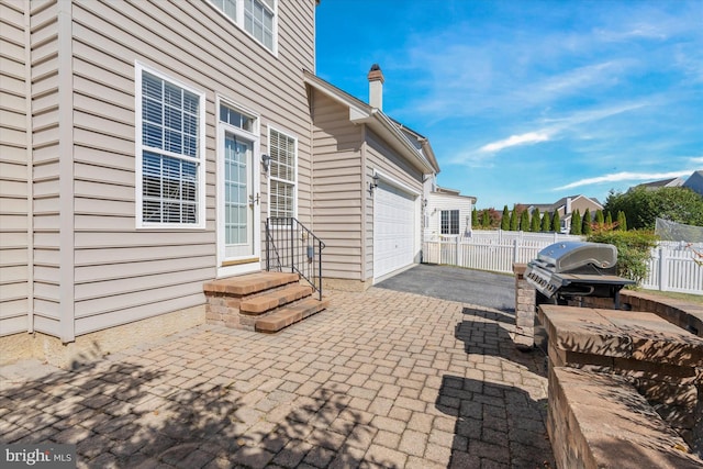 view of patio with grilling area and a garage