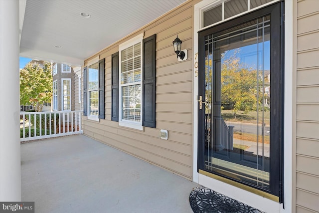 view of exterior entry with a porch