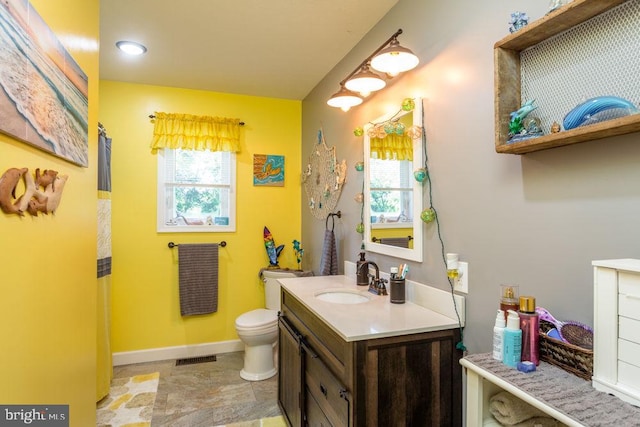 bathroom featuring toilet and vanity