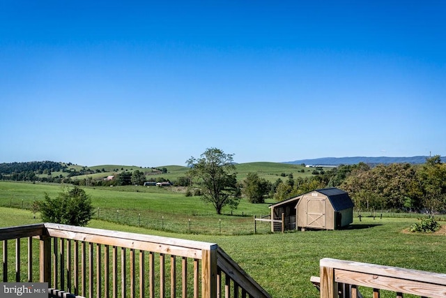 view of yard with a storage unit and a rural view