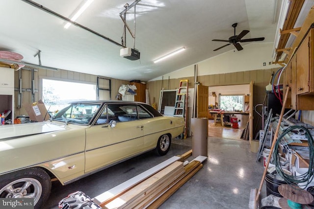 garage with a garage door opener and ceiling fan