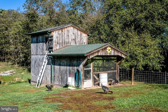 view of outbuilding featuring a lawn