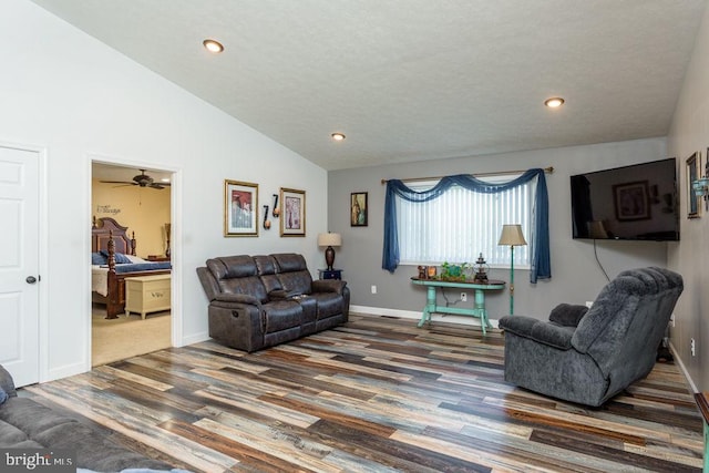 living room with high vaulted ceiling, ceiling fan, dark wood-type flooring, and a textured ceiling