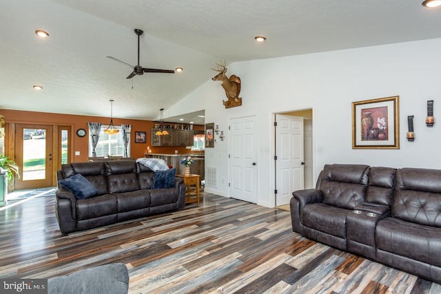 living room with high vaulted ceiling, ceiling fan, and dark hardwood / wood-style flooring