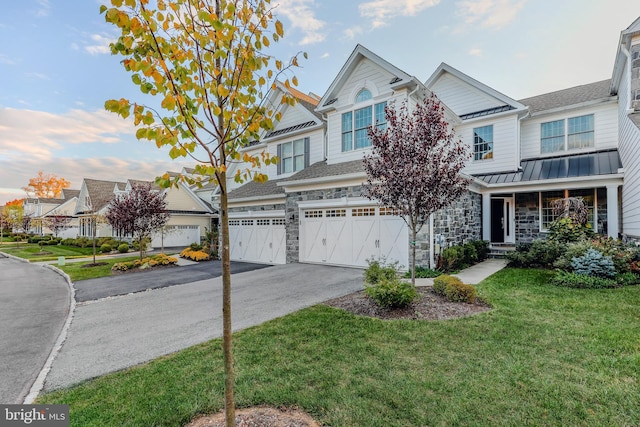 view of property featuring a front yard and a garage