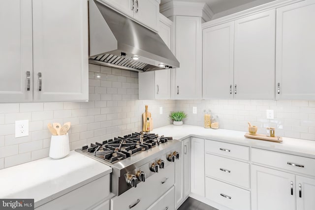 kitchen with stainless steel gas stovetop, tasteful backsplash, and white cabinetry