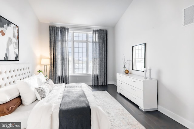 bedroom featuring vaulted ceiling and dark hardwood / wood-style flooring