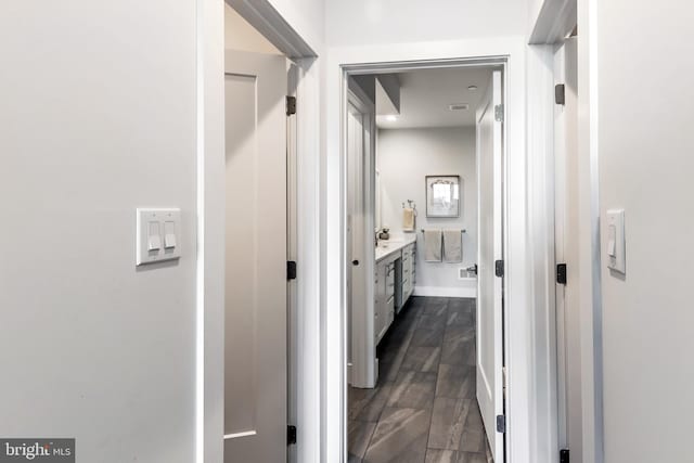 corridor with dark hardwood / wood-style floors