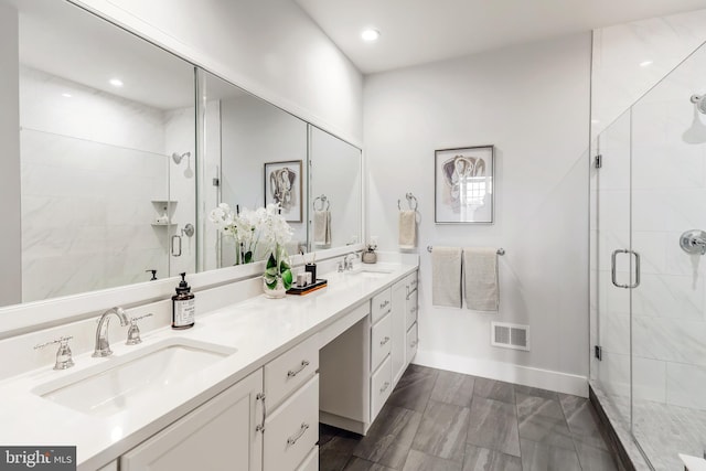 bathroom with walk in shower and vanity