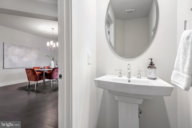 bathroom featuring a chandelier and hardwood / wood-style flooring