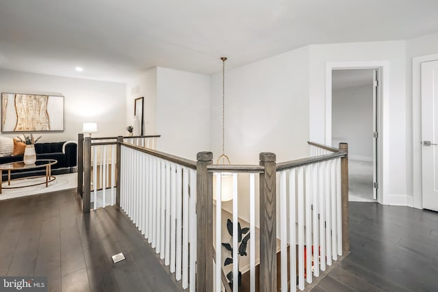 hallway with dark hardwood / wood-style flooring