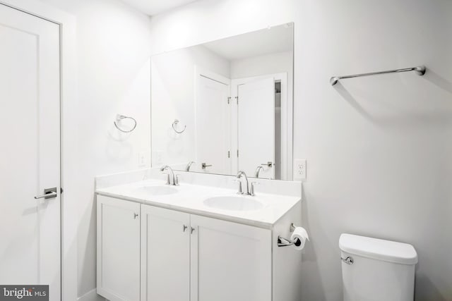 bathroom with toilet and vanity