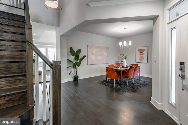 dining area featuring an inviting chandelier and dark wood-type flooring