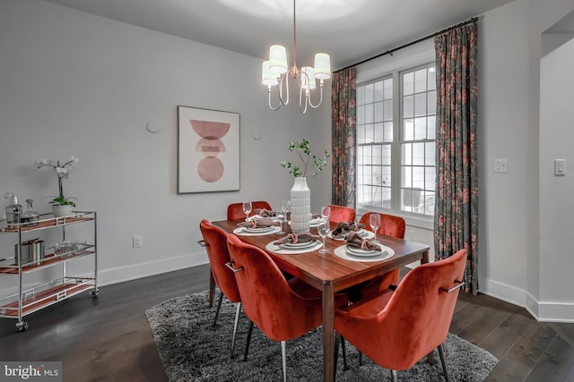 dining room with an inviting chandelier and dark hardwood / wood-style flooring