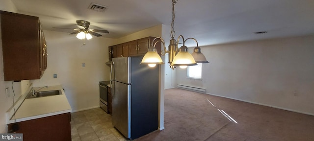 kitchen featuring a sink, a ceiling fan, visible vents, freestanding refrigerator, and a baseboard radiator
