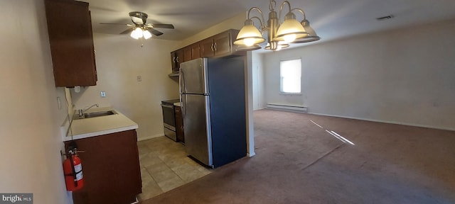 kitchen with a sink, a baseboard radiator, visible vents, freestanding refrigerator, and range with electric stovetop