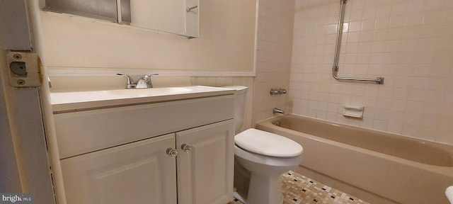 full bathroom featuring wainscoting, toilet, tub / shower combination, and vanity