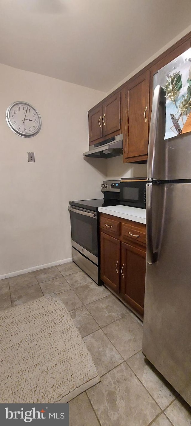 kitchen with appliances with stainless steel finishes and dark brown cabinetry