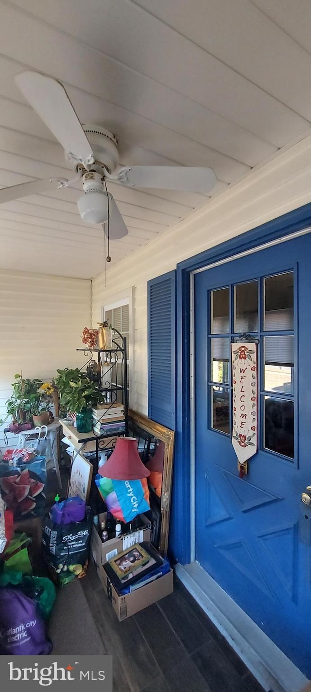 doorway to property with ceiling fan