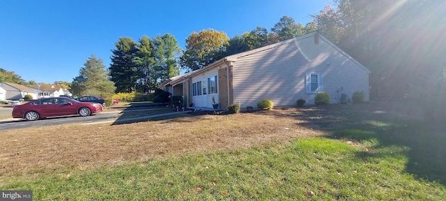 view of side of home featuring a yard