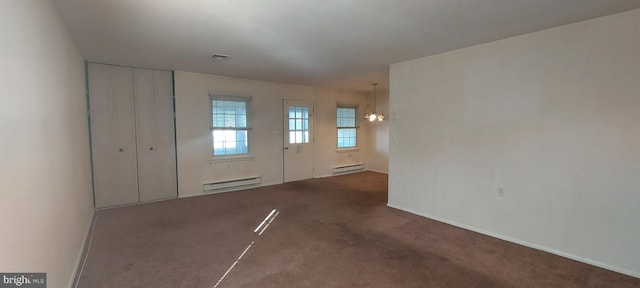 entryway featuring an inviting chandelier, a baseboard radiator, visible vents, and carpet flooring