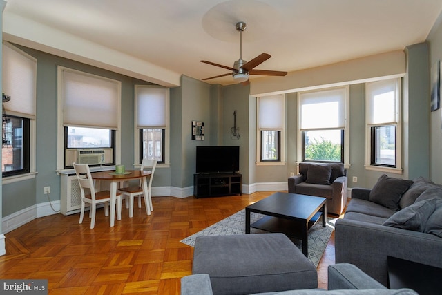 living room with cooling unit, ceiling fan, and parquet floors