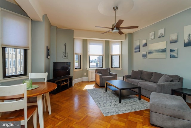 living room featuring light parquet floors and ceiling fan