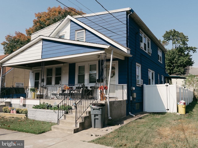 bungalow-style house with a porch and cooling unit