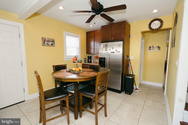 dining space with light tile patterned floors and ceiling fan