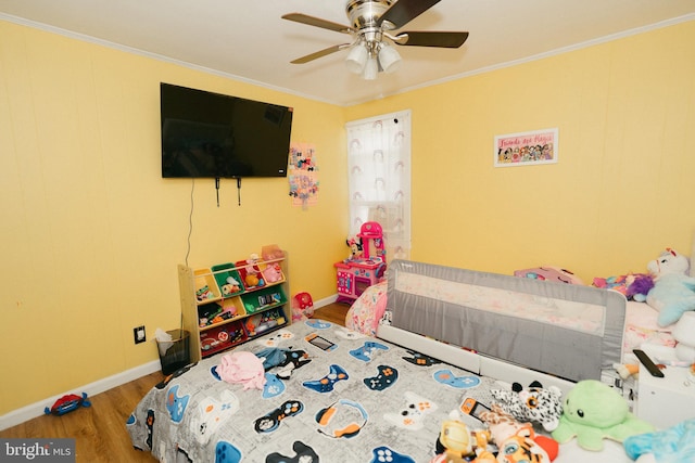 bedroom with wood-type flooring, ornamental molding, and ceiling fan