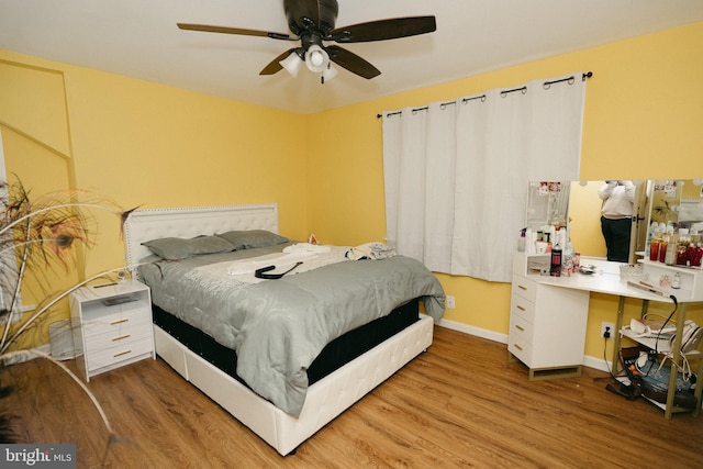 bedroom with ceiling fan and light hardwood / wood-style flooring