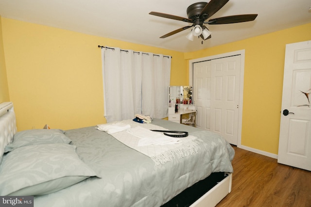 bedroom featuring wood-type flooring, a closet, and ceiling fan