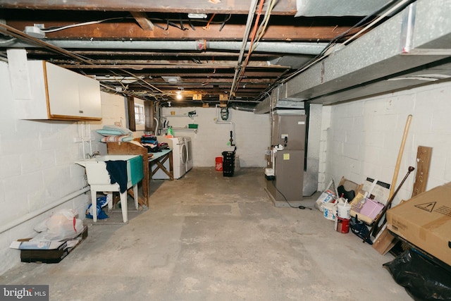 basement featuring independent washer and dryer and heating unit