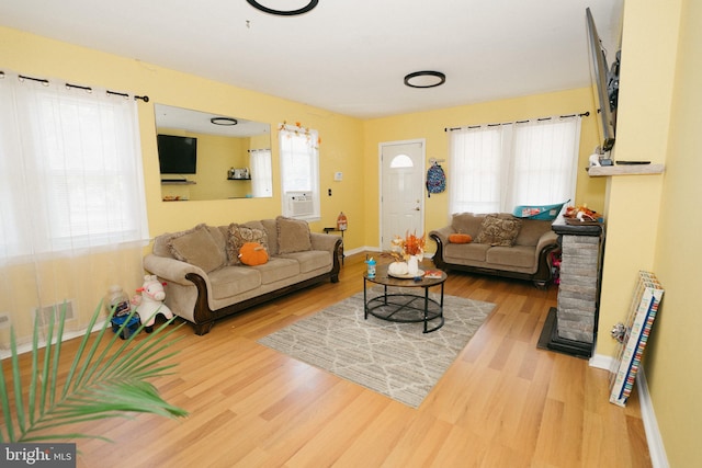 living room with hardwood / wood-style flooring and cooling unit