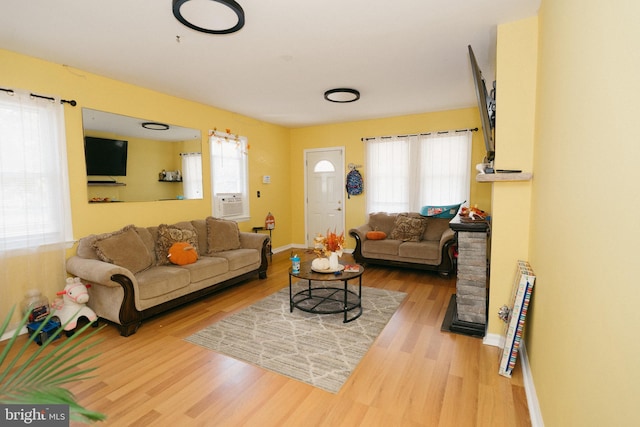 living room featuring plenty of natural light and hardwood / wood-style flooring