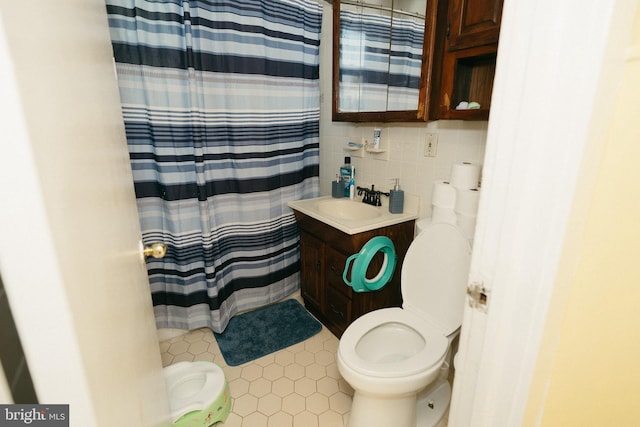 bathroom with vanity, tile walls, curtained shower, toilet, and backsplash