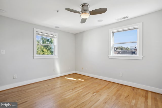 spare room with light wood-type flooring and ceiling fan