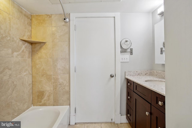 bathroom featuring vanity, tiled shower / bath combo, and tile patterned flooring