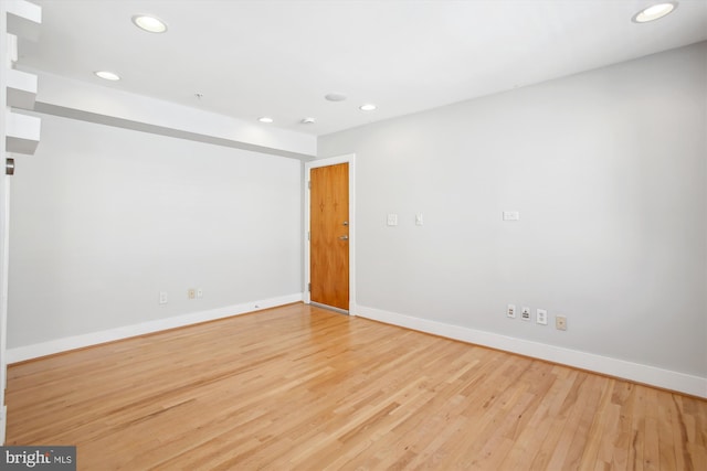 spare room with light hardwood / wood-style flooring