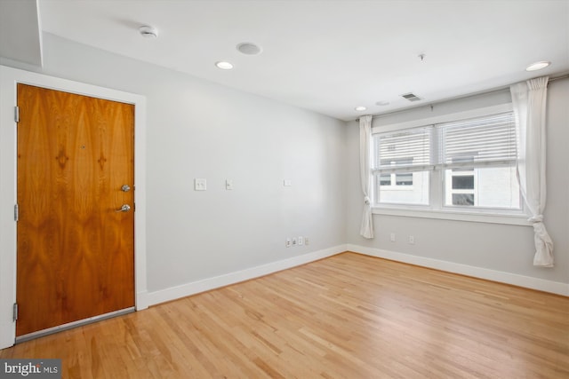 empty room with light hardwood / wood-style flooring