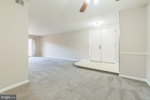 carpeted empty room featuring ceiling fan