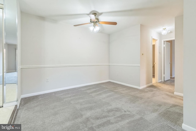 empty room featuring light carpet and ceiling fan