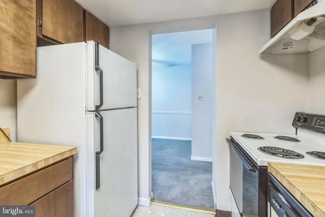 kitchen featuring light carpet, wood counters, and white appliances