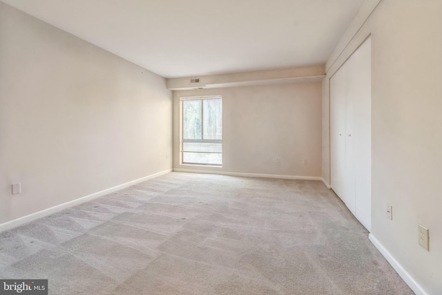 empty room featuring light carpet