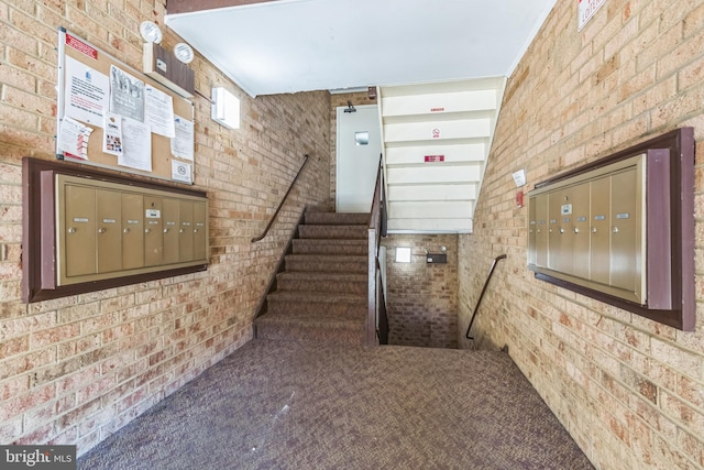 stairs with brick wall and carpet floors