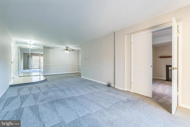 carpeted empty room with ceiling fan